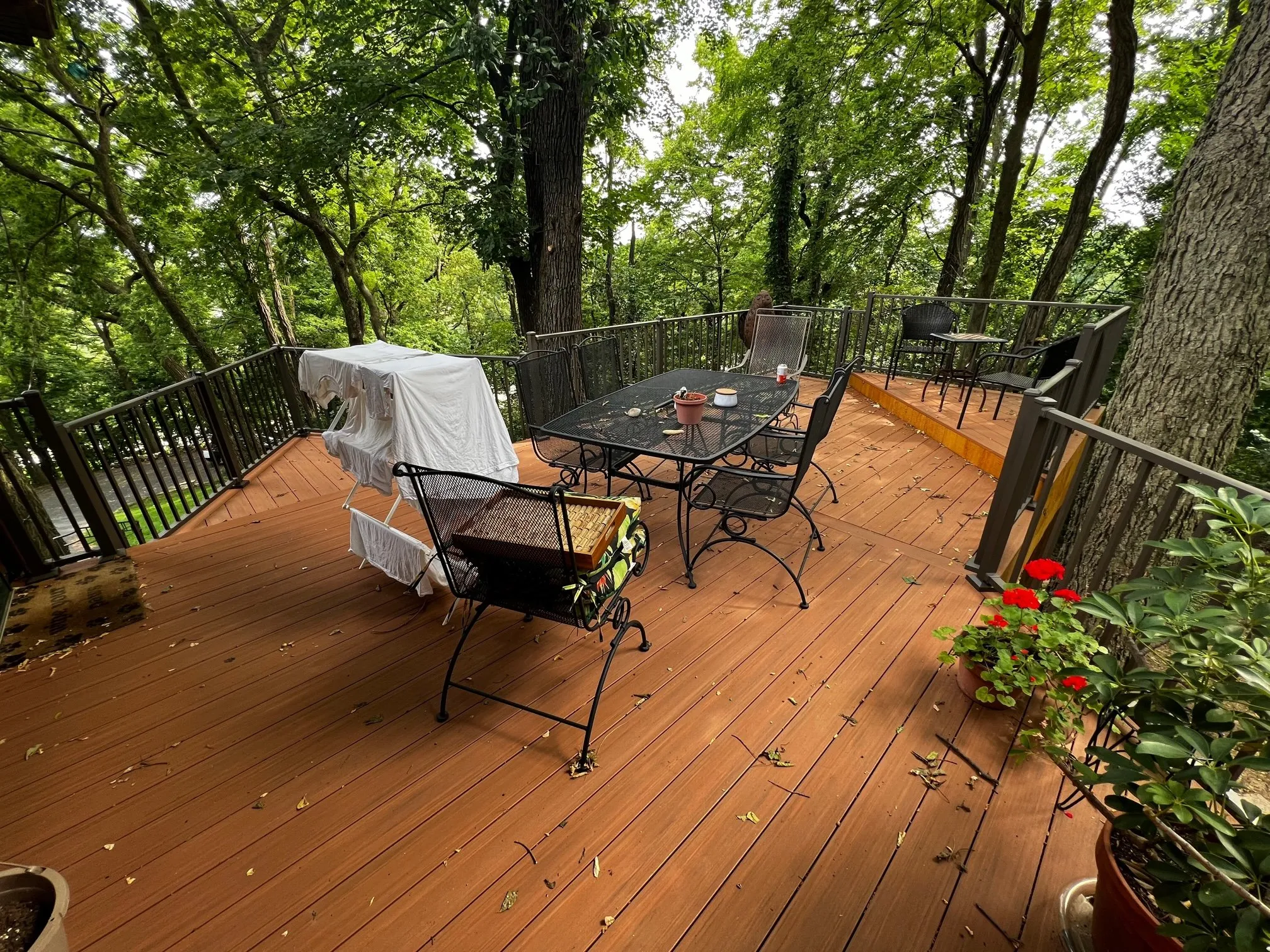 Deck surface with outdoor dining set up in the treetops