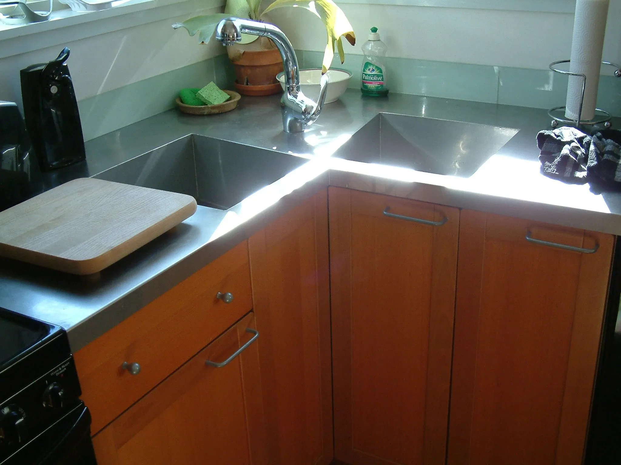 Stainless steel counters and corner sink in the maple kitchen