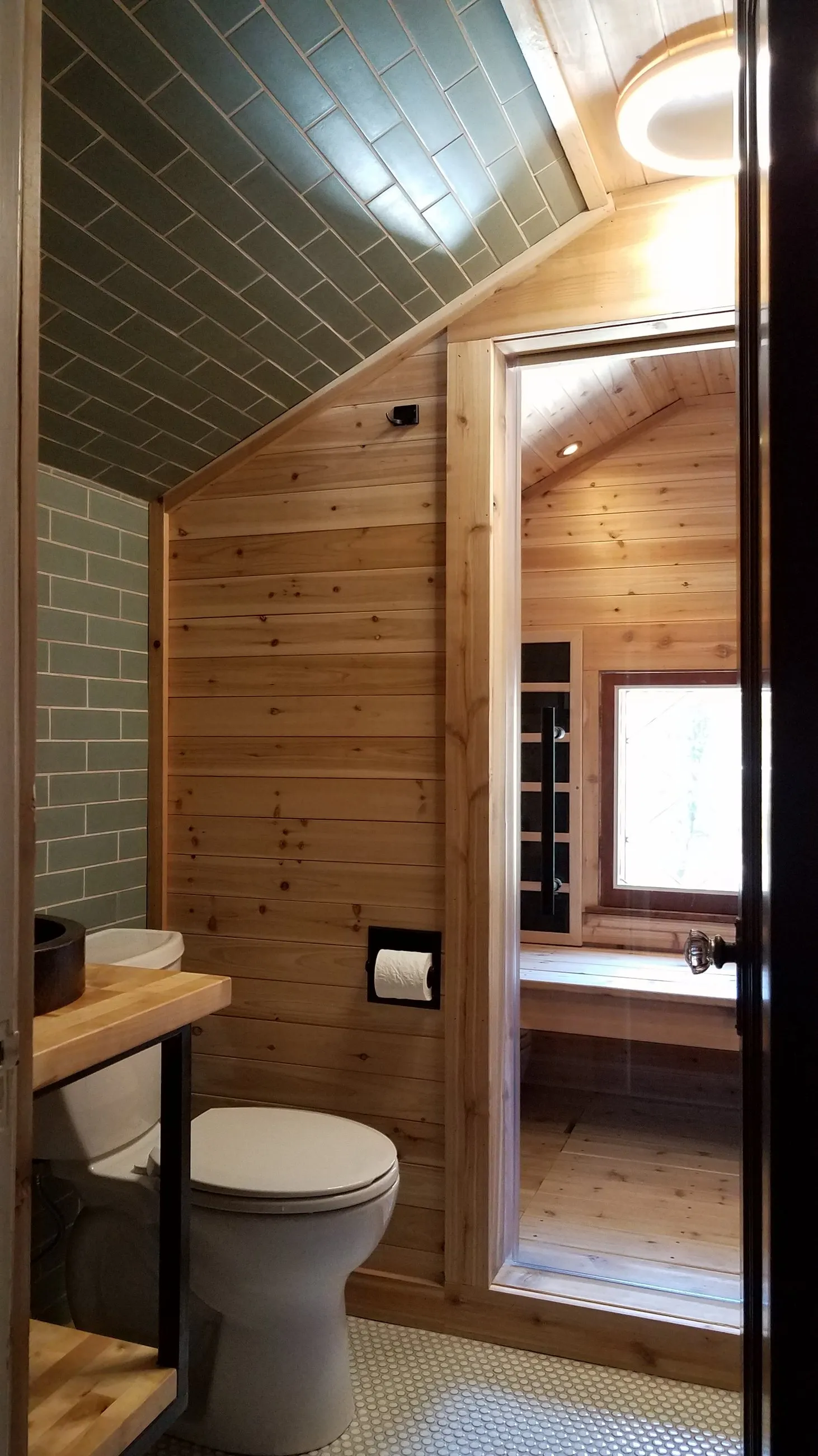Pine-clad bath opening into a private sauna