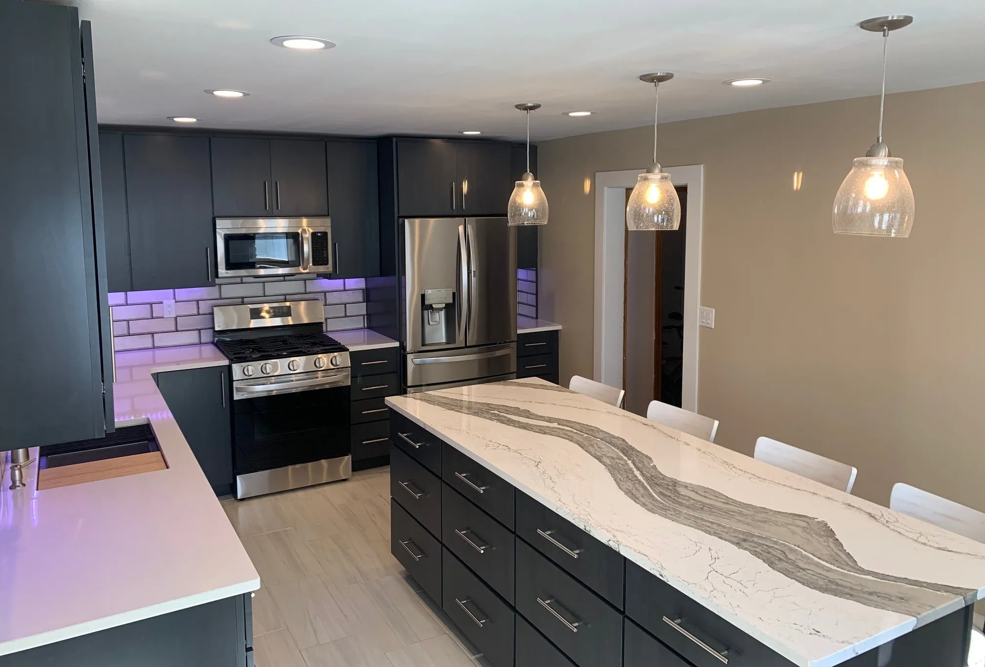 Long veined Cambria quartz island with seating