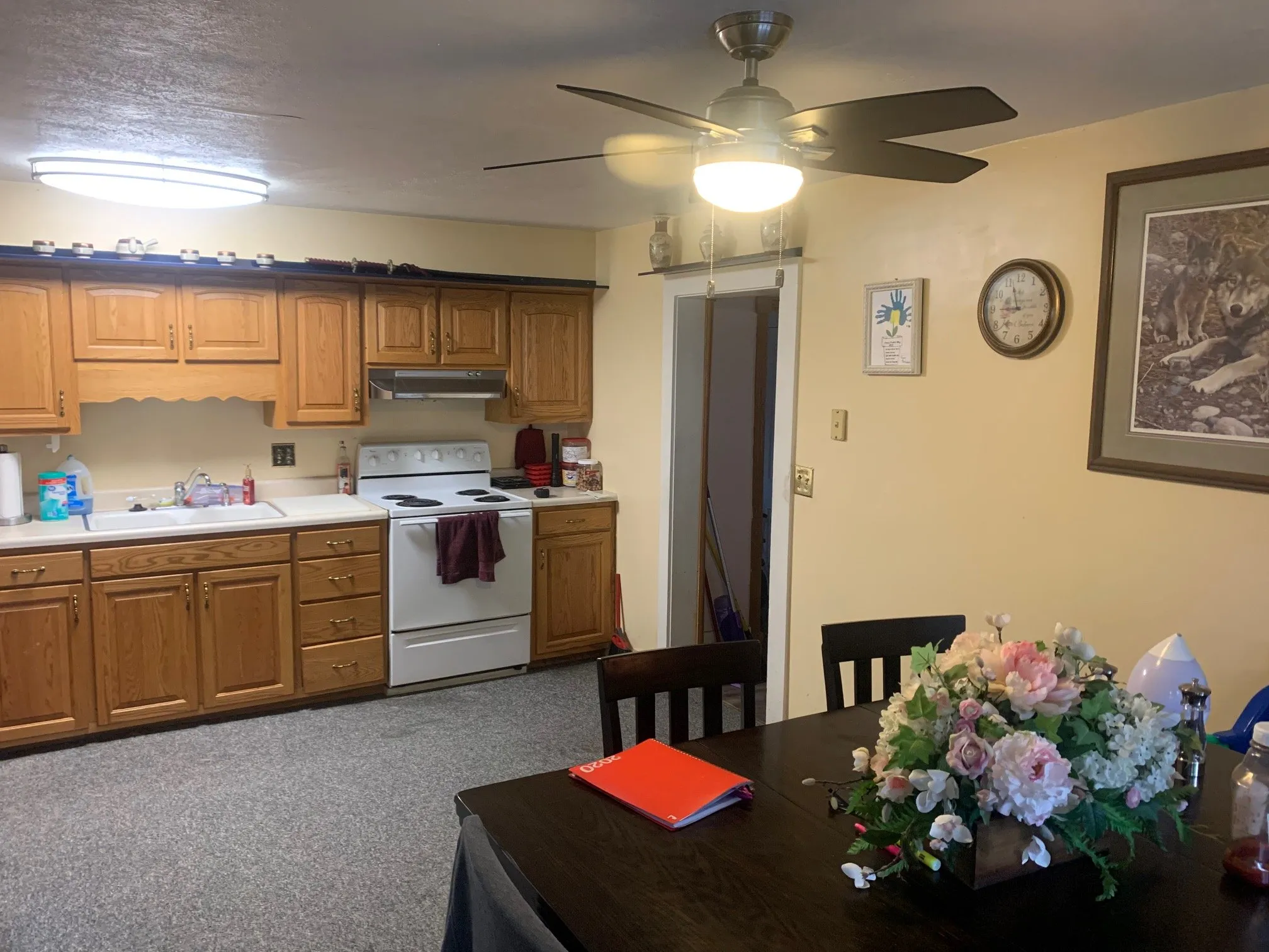The kitchen before the remodel, with oak cabinets and carpet