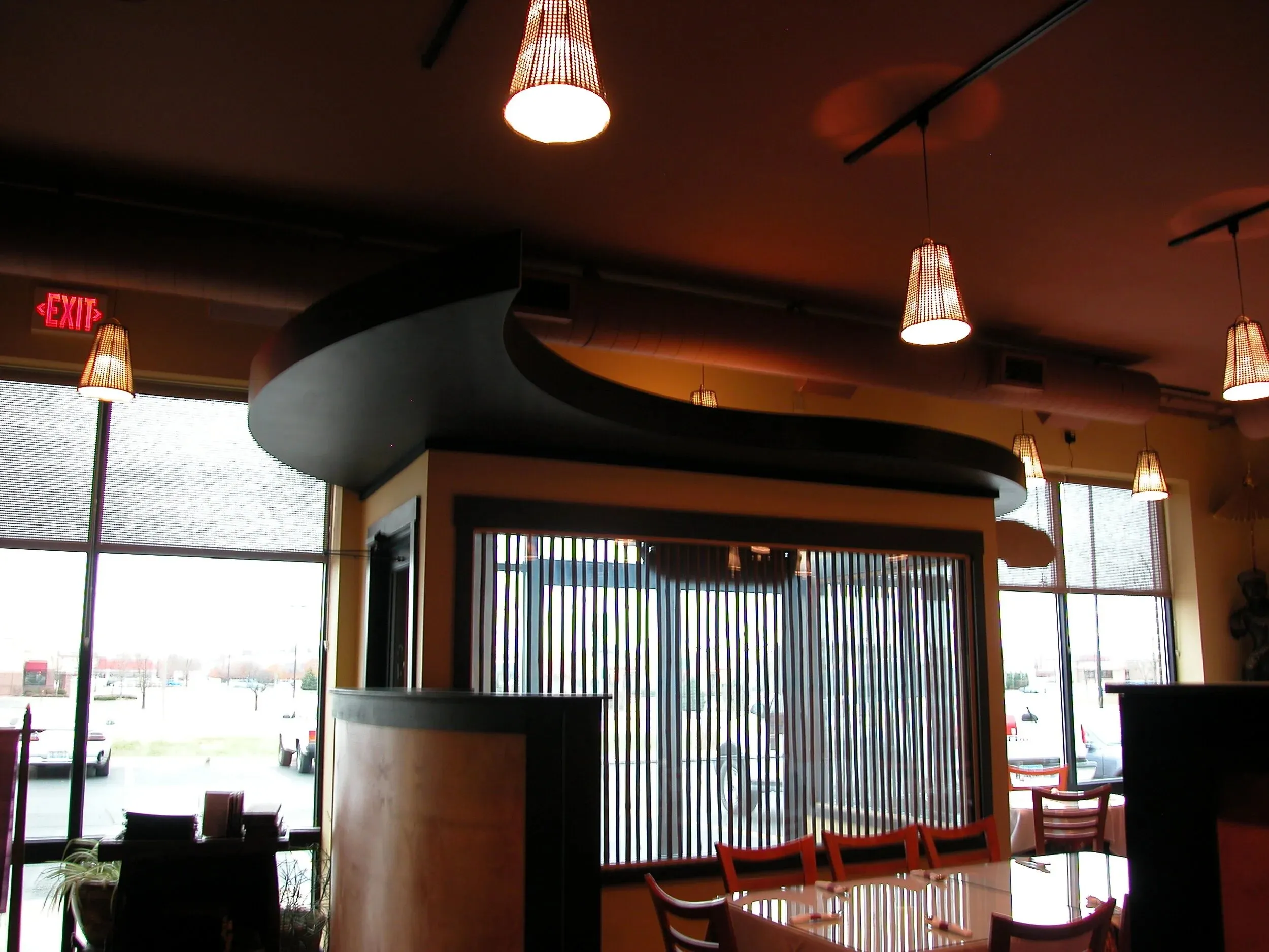 Full restaurant build-out with a curved service counter and pendant lighting