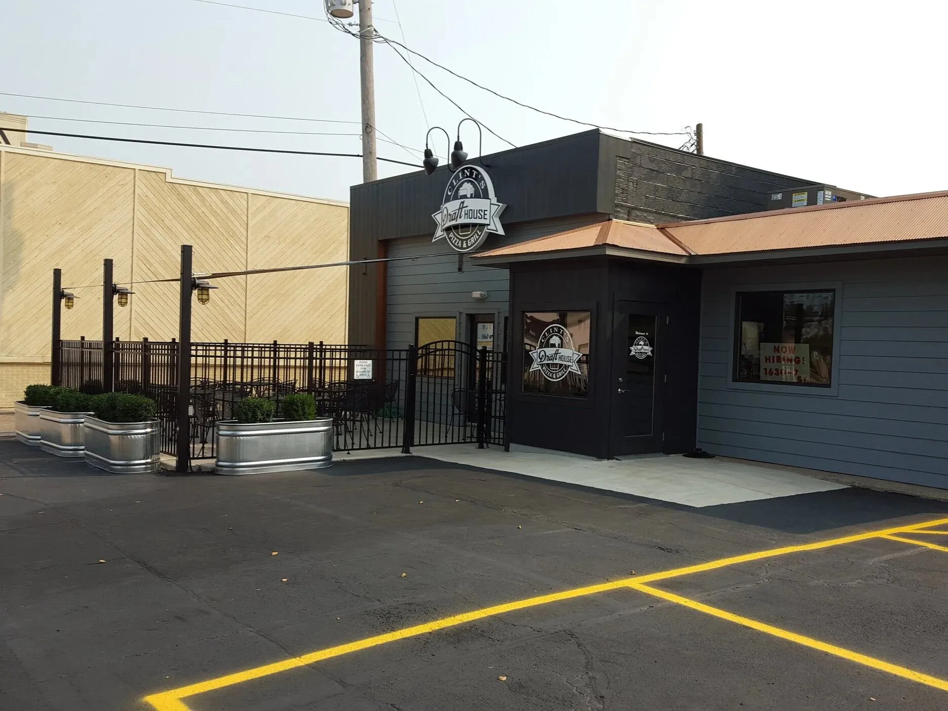 Full exterior and storefront renovation for a pizzeria, with a fenced patio