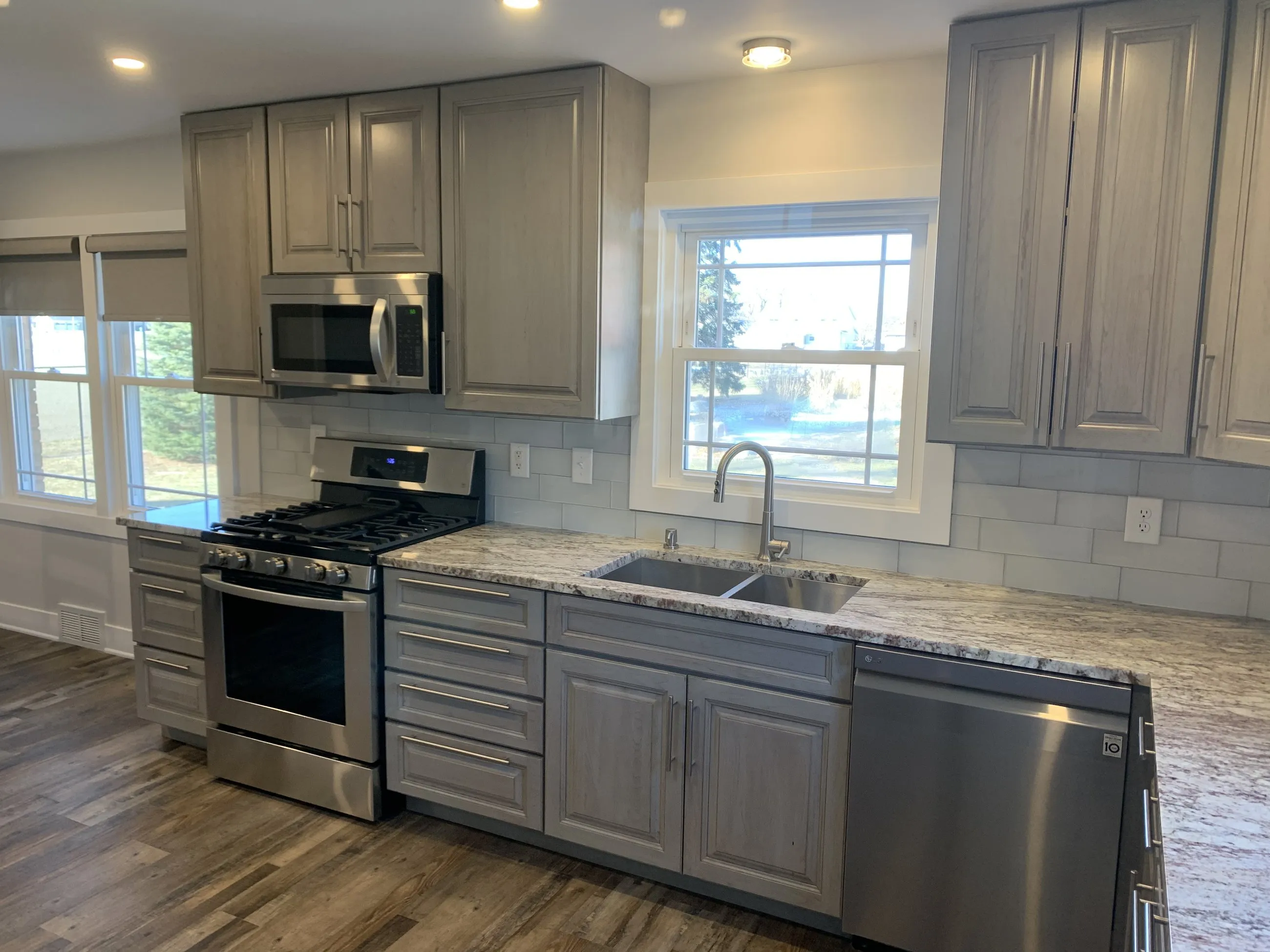 Kitchen sink window wall with subway tile backsplash