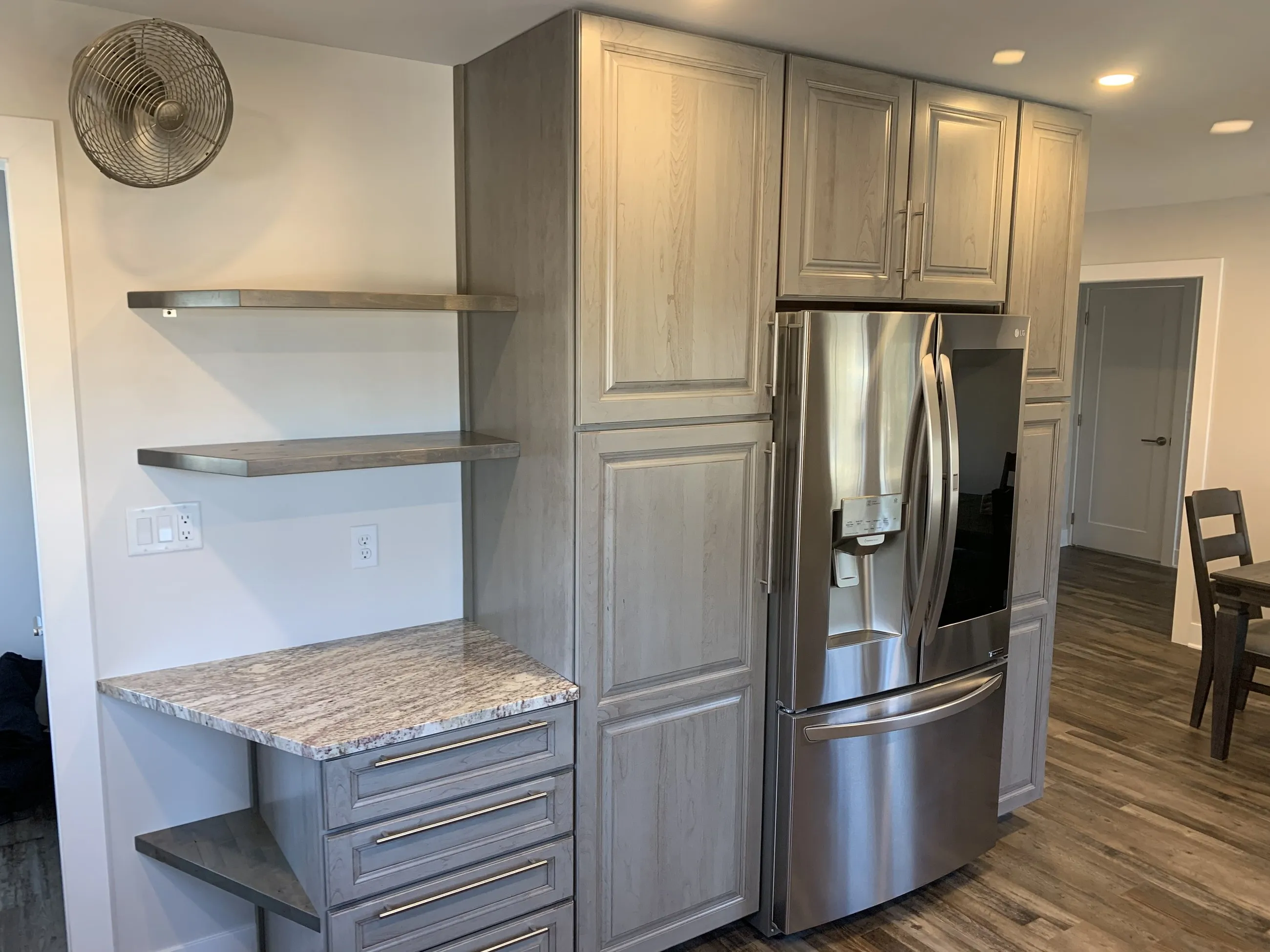 Floating shelves and counter beside the pantry cabinets
