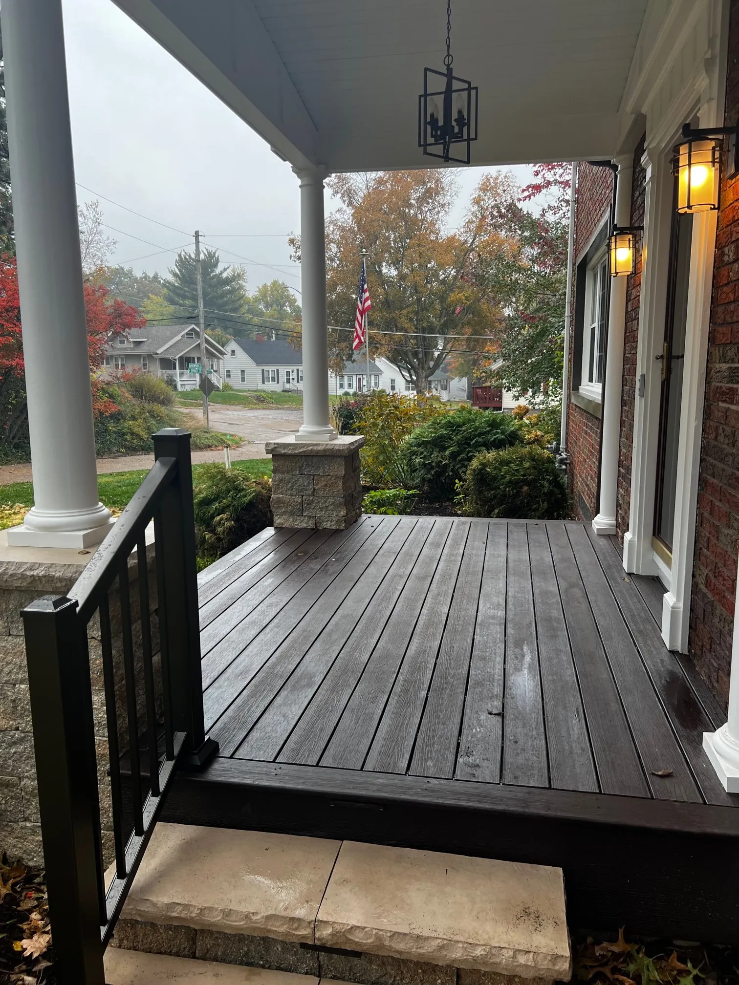 Composite porch deck with lantern lighting at the door