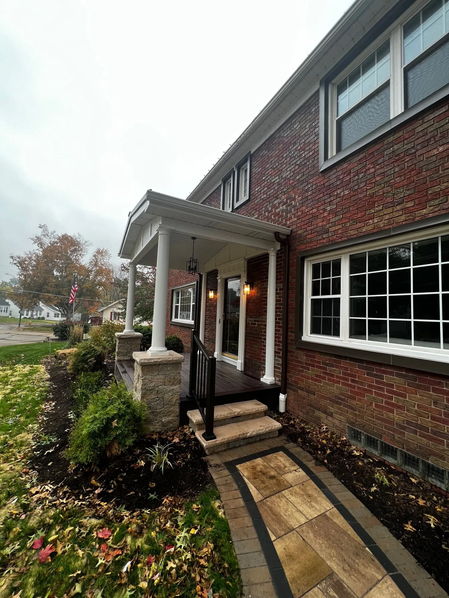 Paver walk and porch along the brick facade