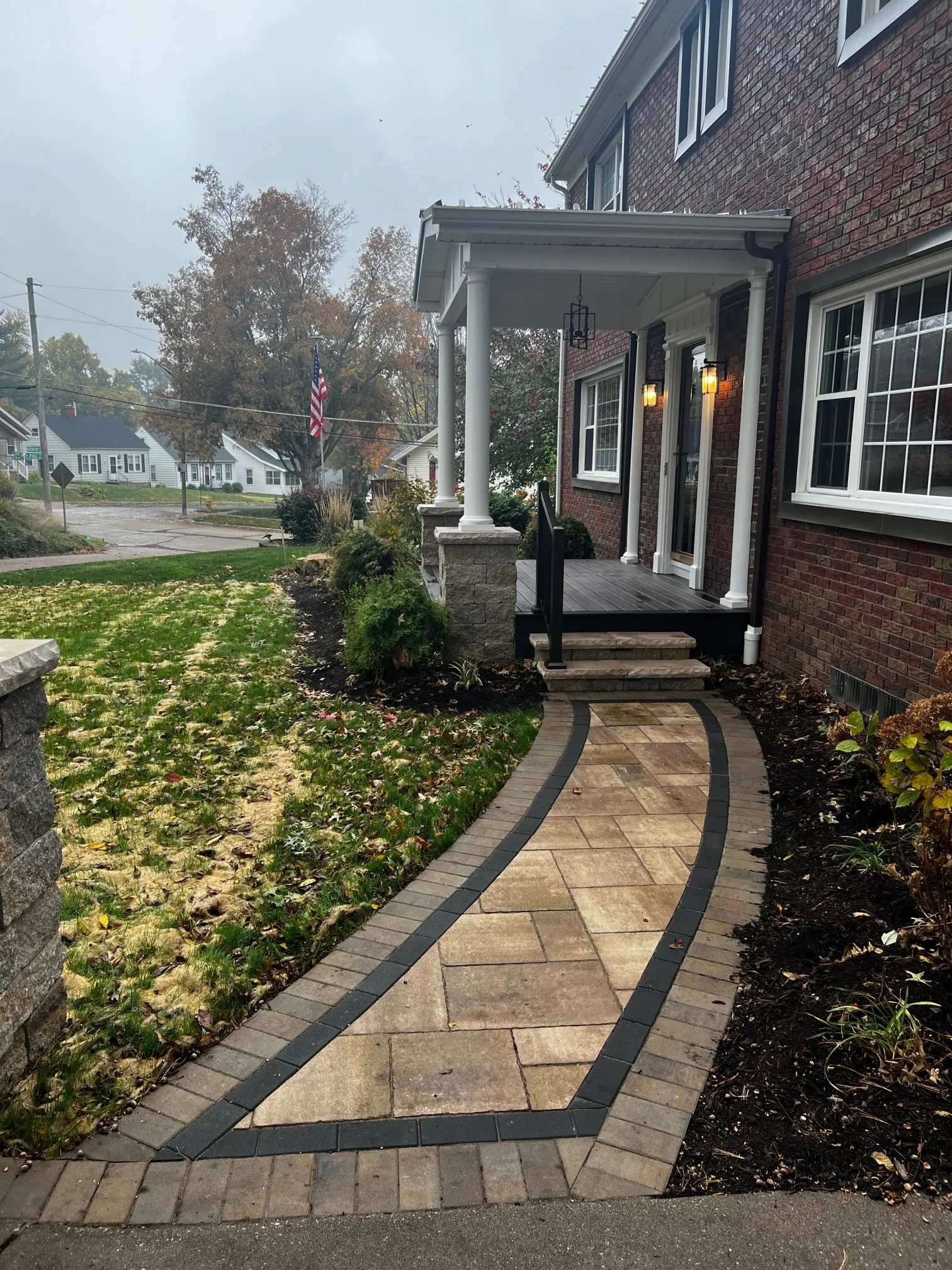Paver walkway with dark border leading to the porch