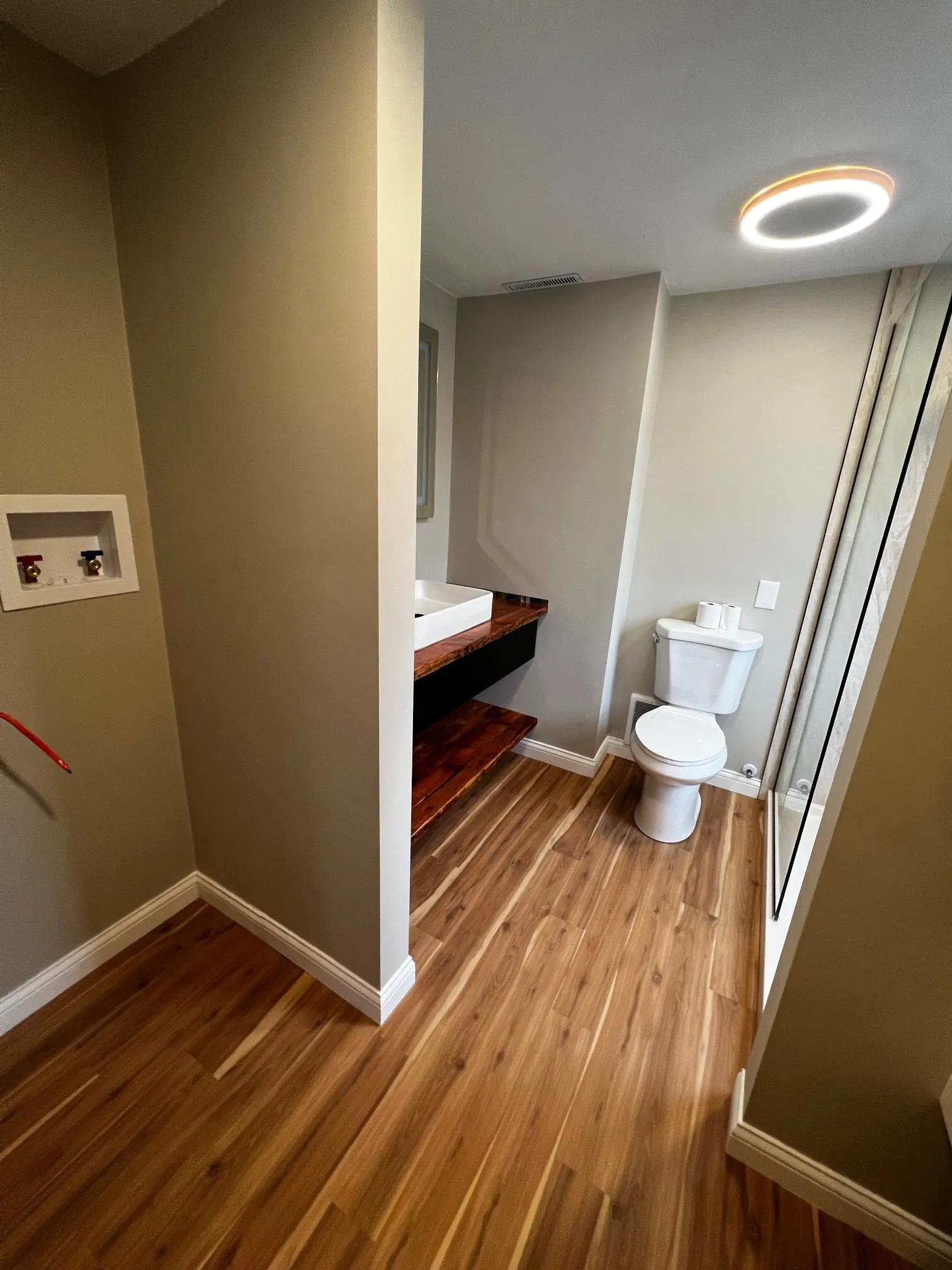 View into the master bath with wood-look floor