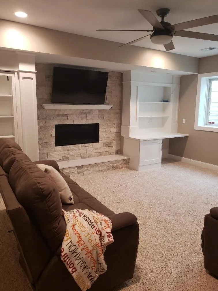 Reclining sofa facing the stone fireplace media wall