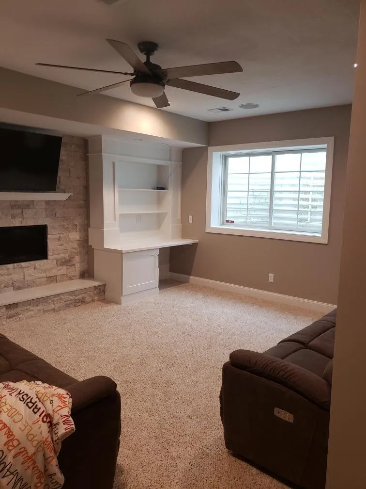 Basement corner with ceiling fan and daylight window