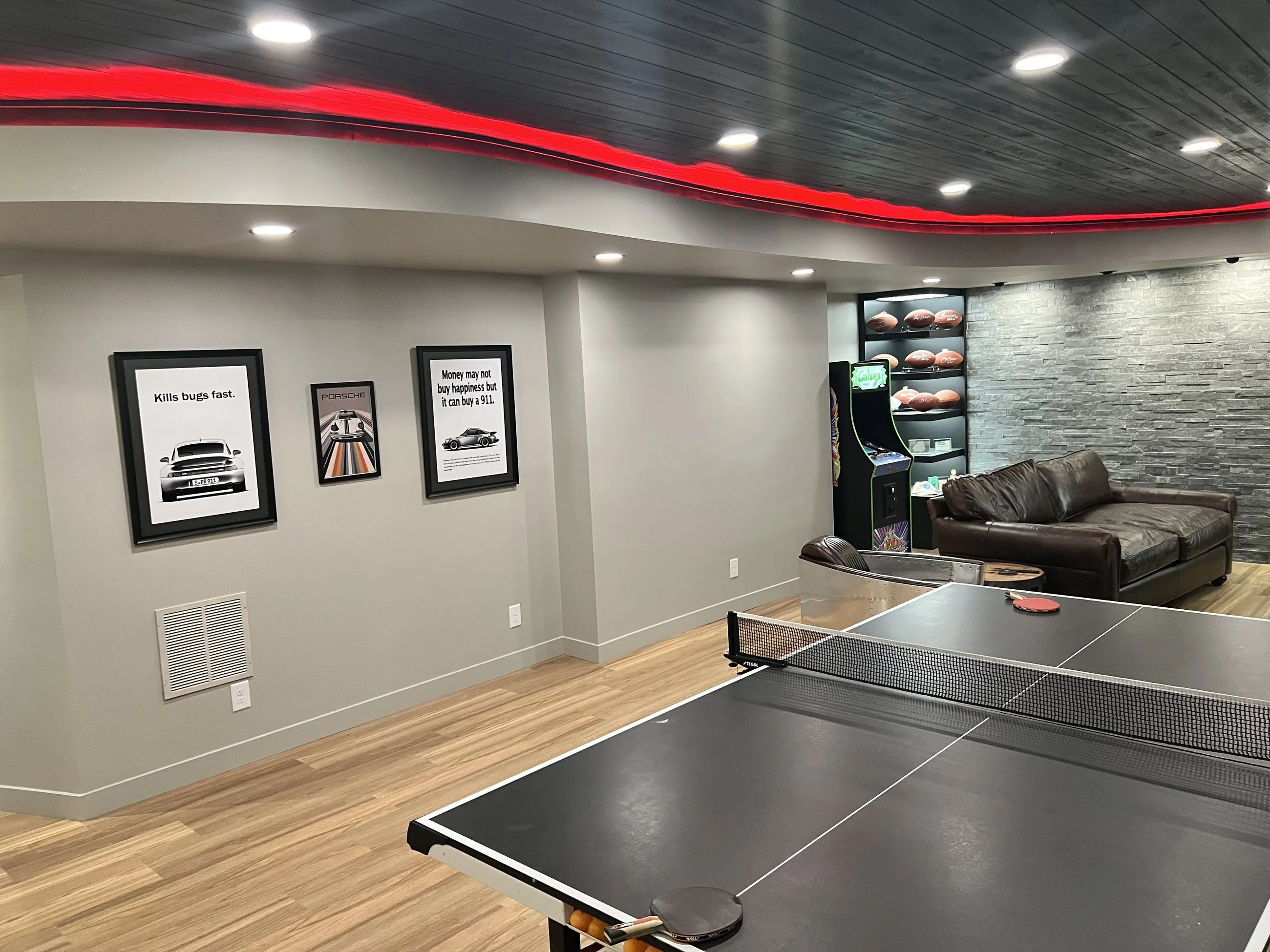 Table tennis under the curved red-lit soffit