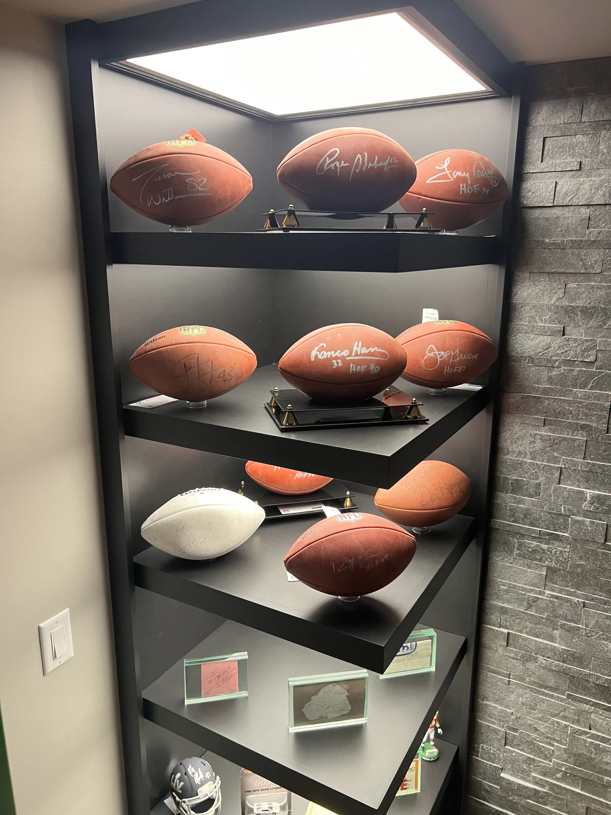 Signed footballs on backlit corner shelves