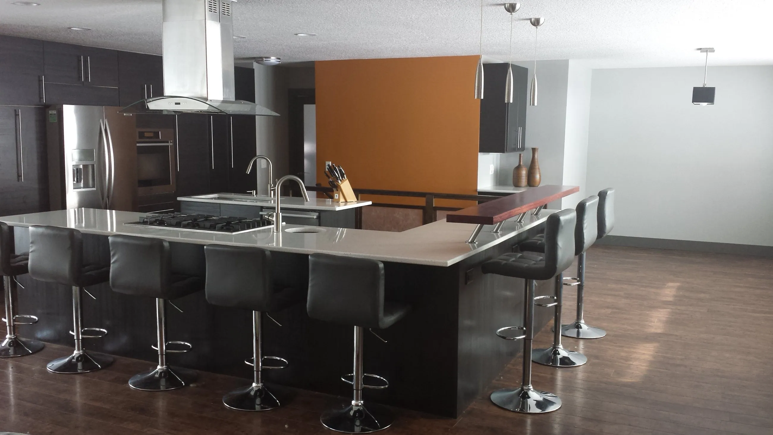Raised dark red bar rail with black leather stools