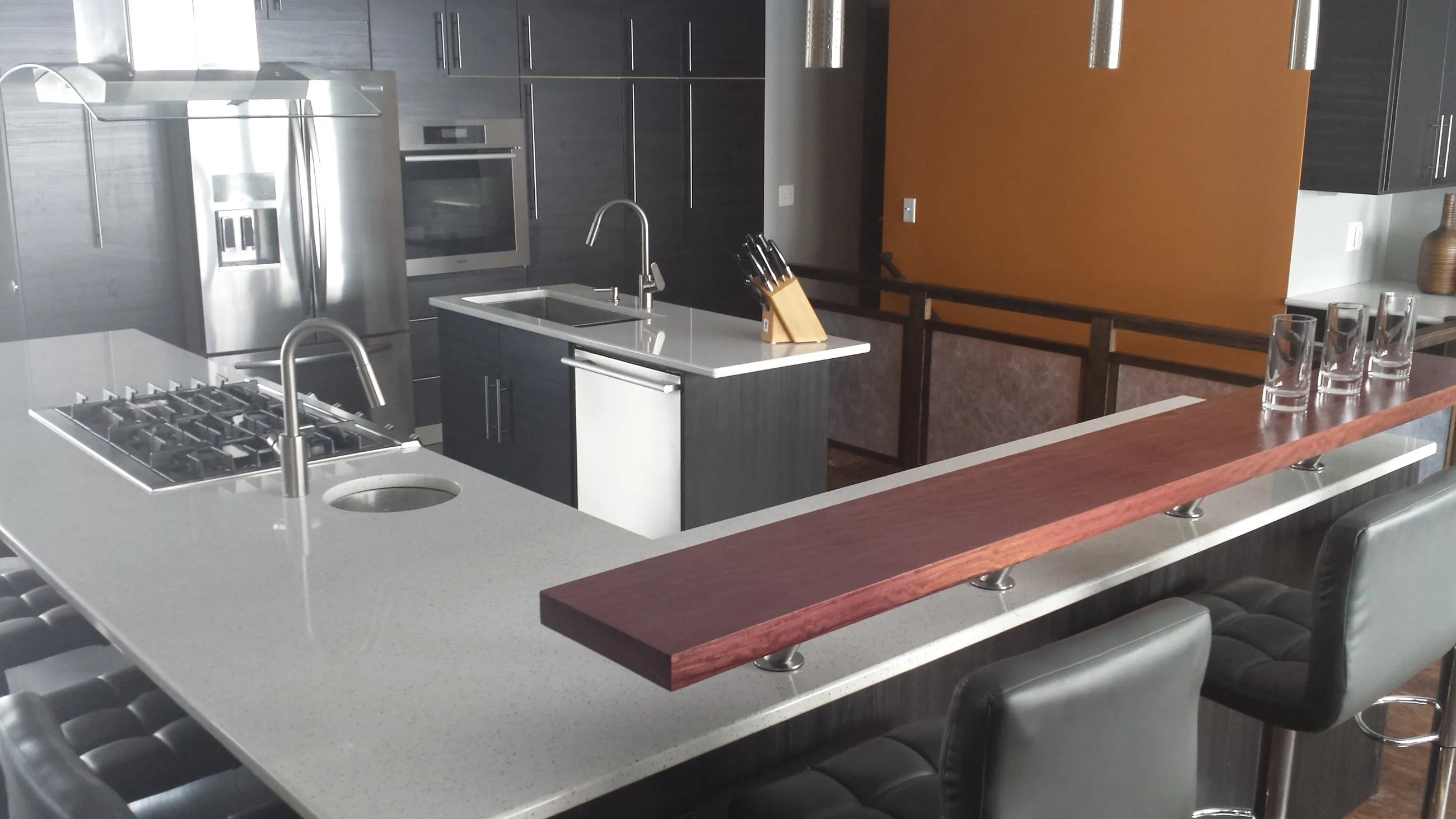 Island cooktop and raised bar in the open kitchen