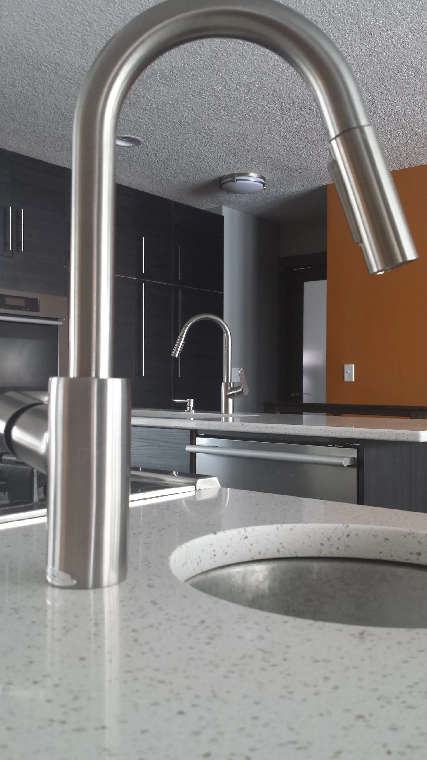 Brushed steel faucet over the island prep sink