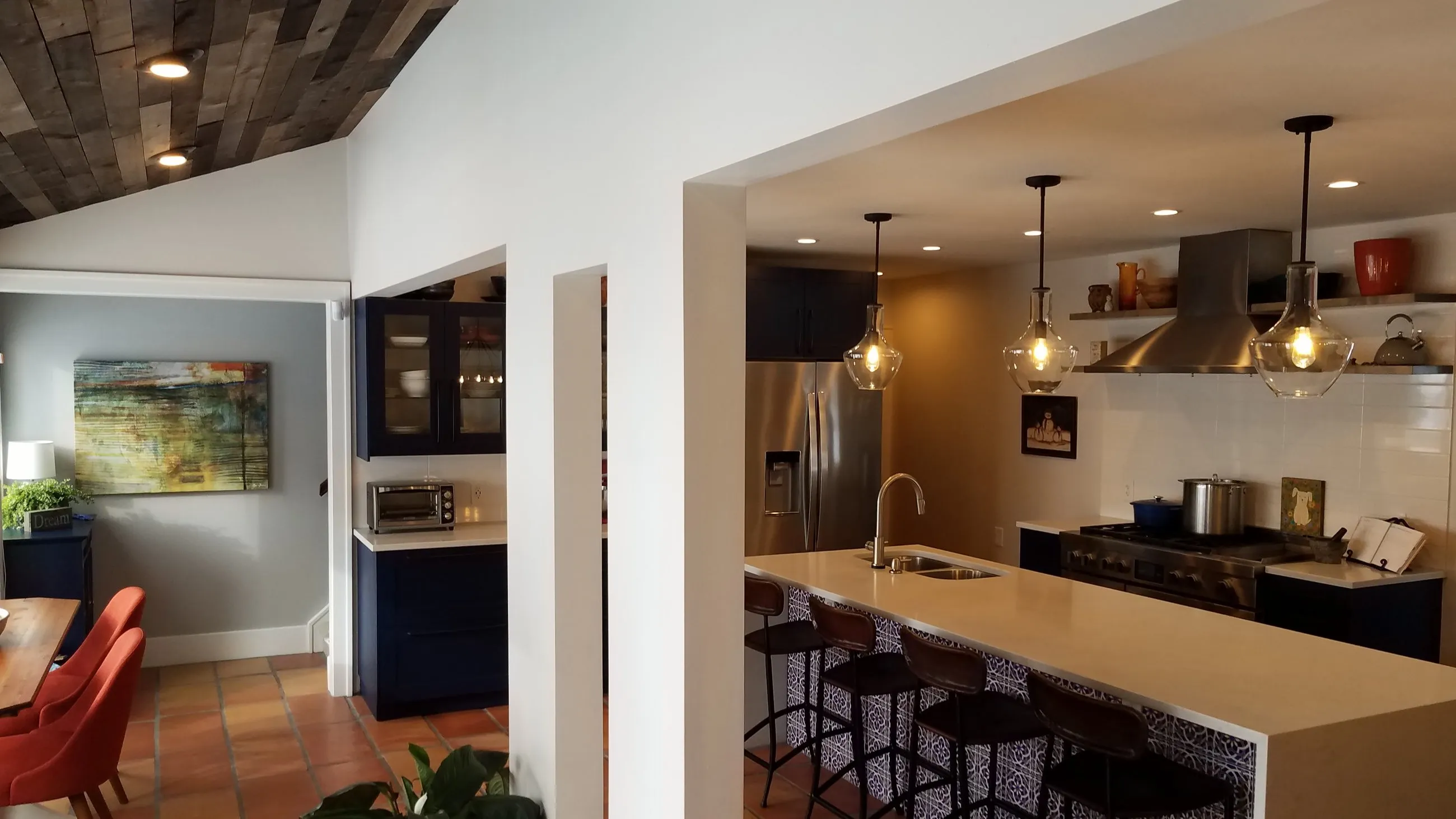 Open kitchen with island pendants and terracotta tile