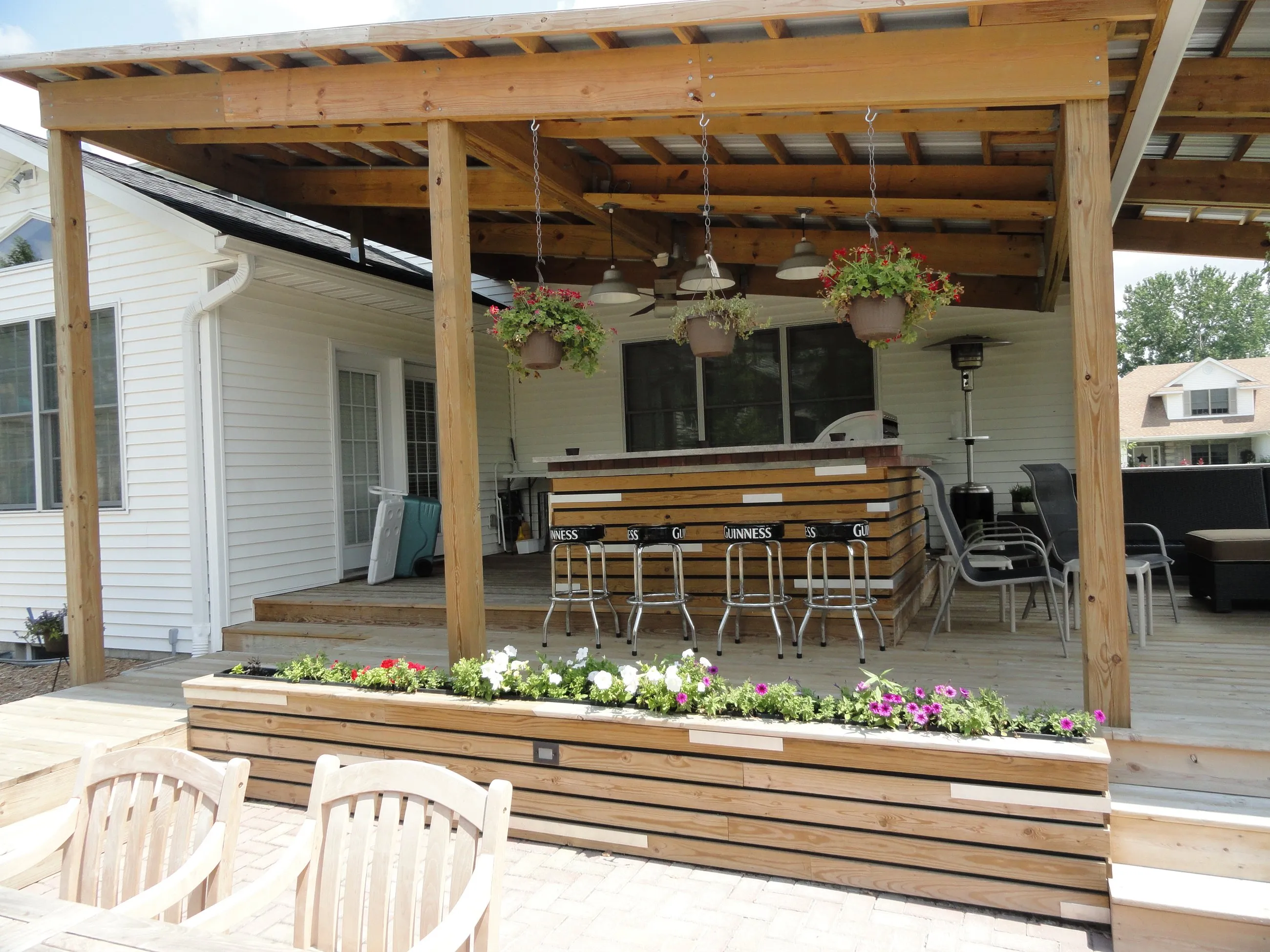 Covered outdoor bar and living area with cedar slat planters