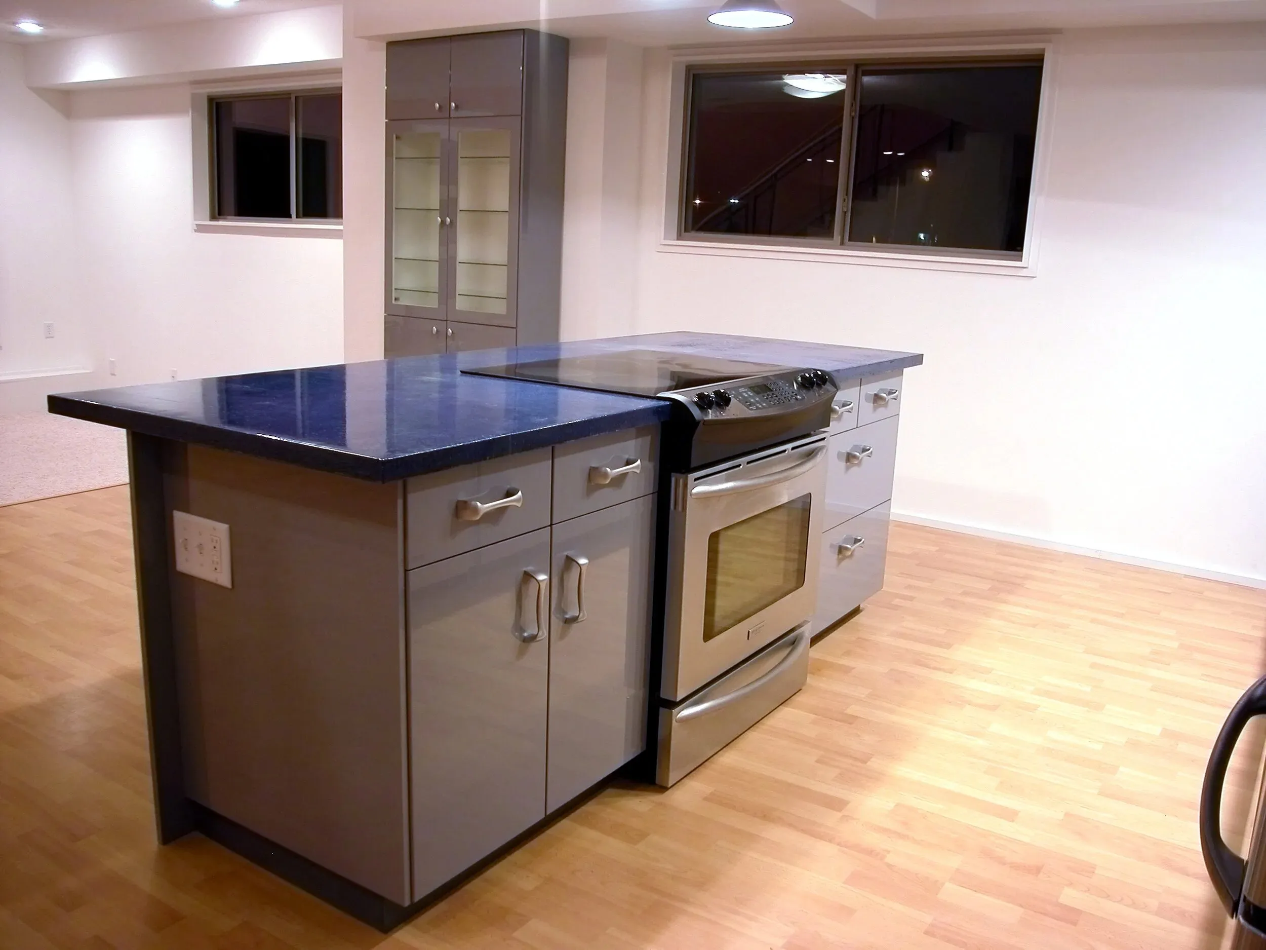 Island end cabinets with the stainless range beyond