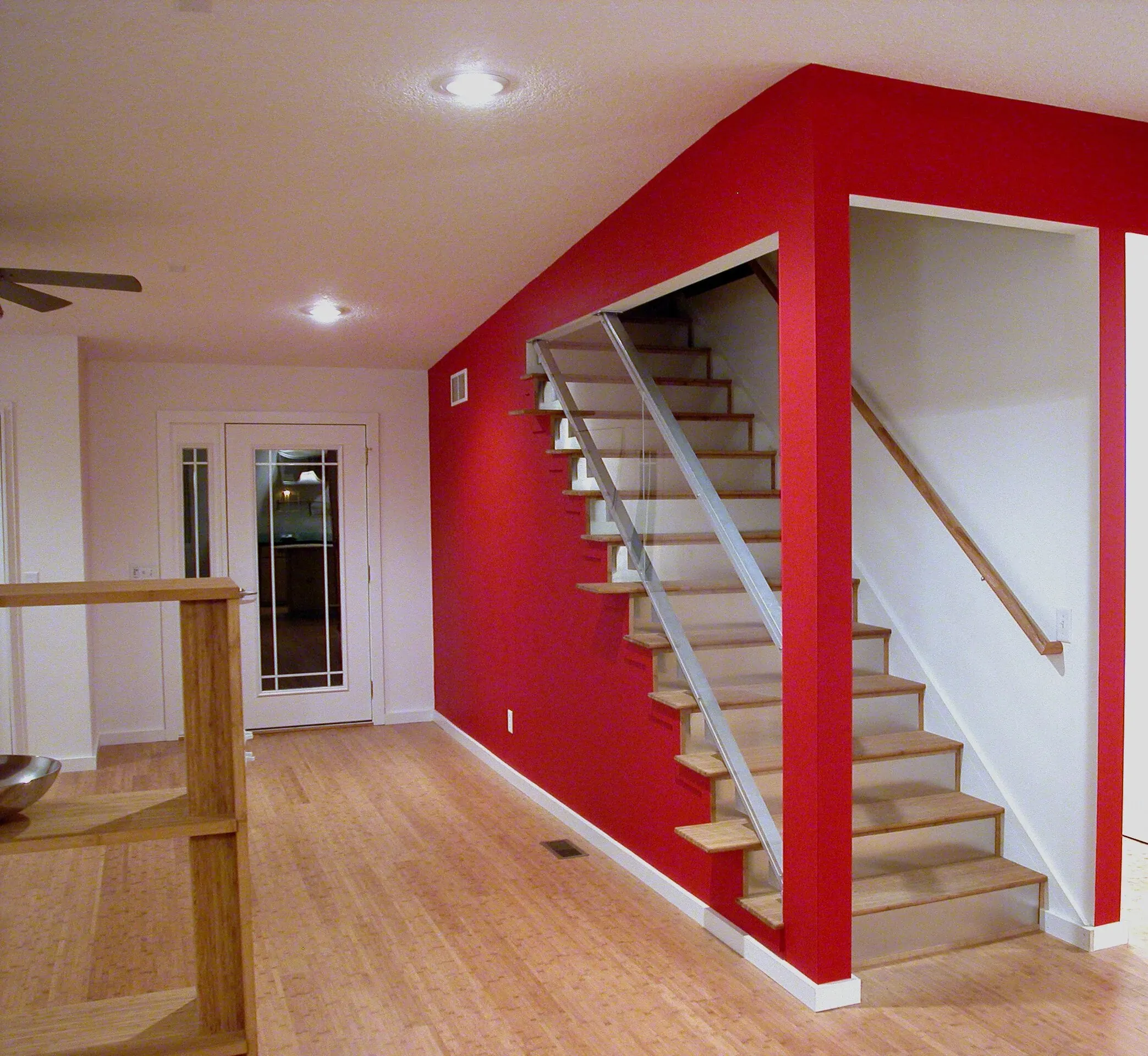 Red feature wall carrying the open stair