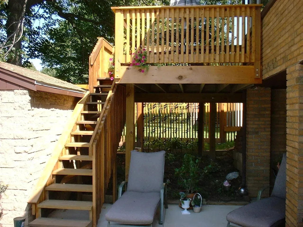 Two-level reclaimed wood deck with stair and seating below