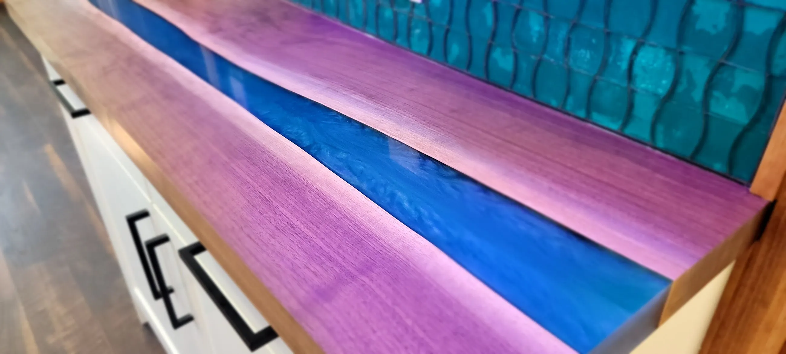 Purple and blue resin river running through a countertop