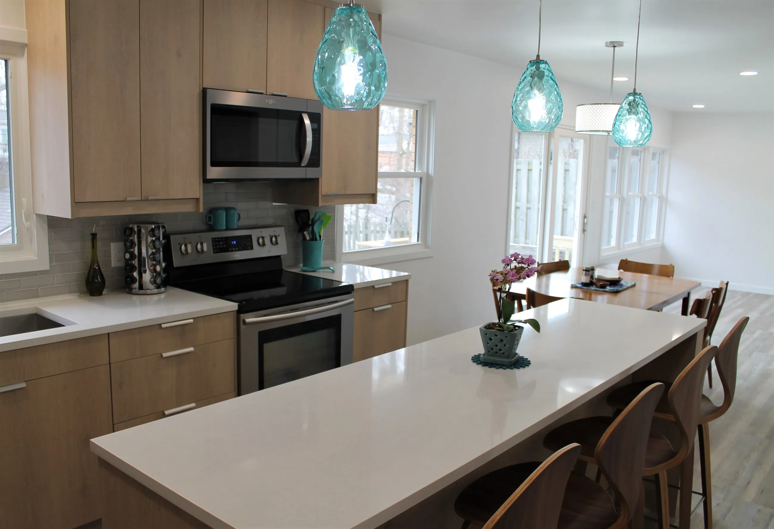 Aqua pendants over the island, appliance wall beyond