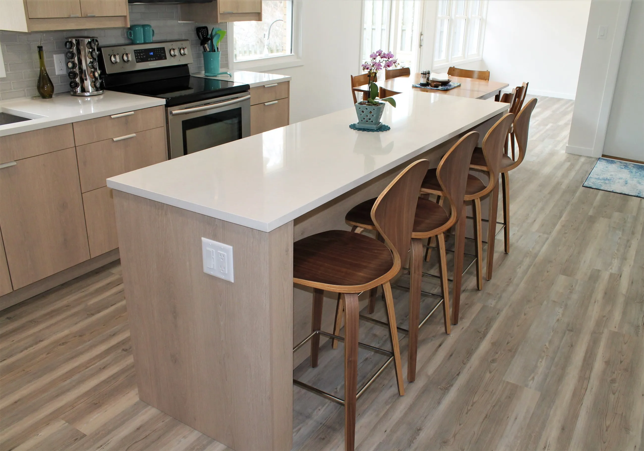 White quartz island with walnut stools