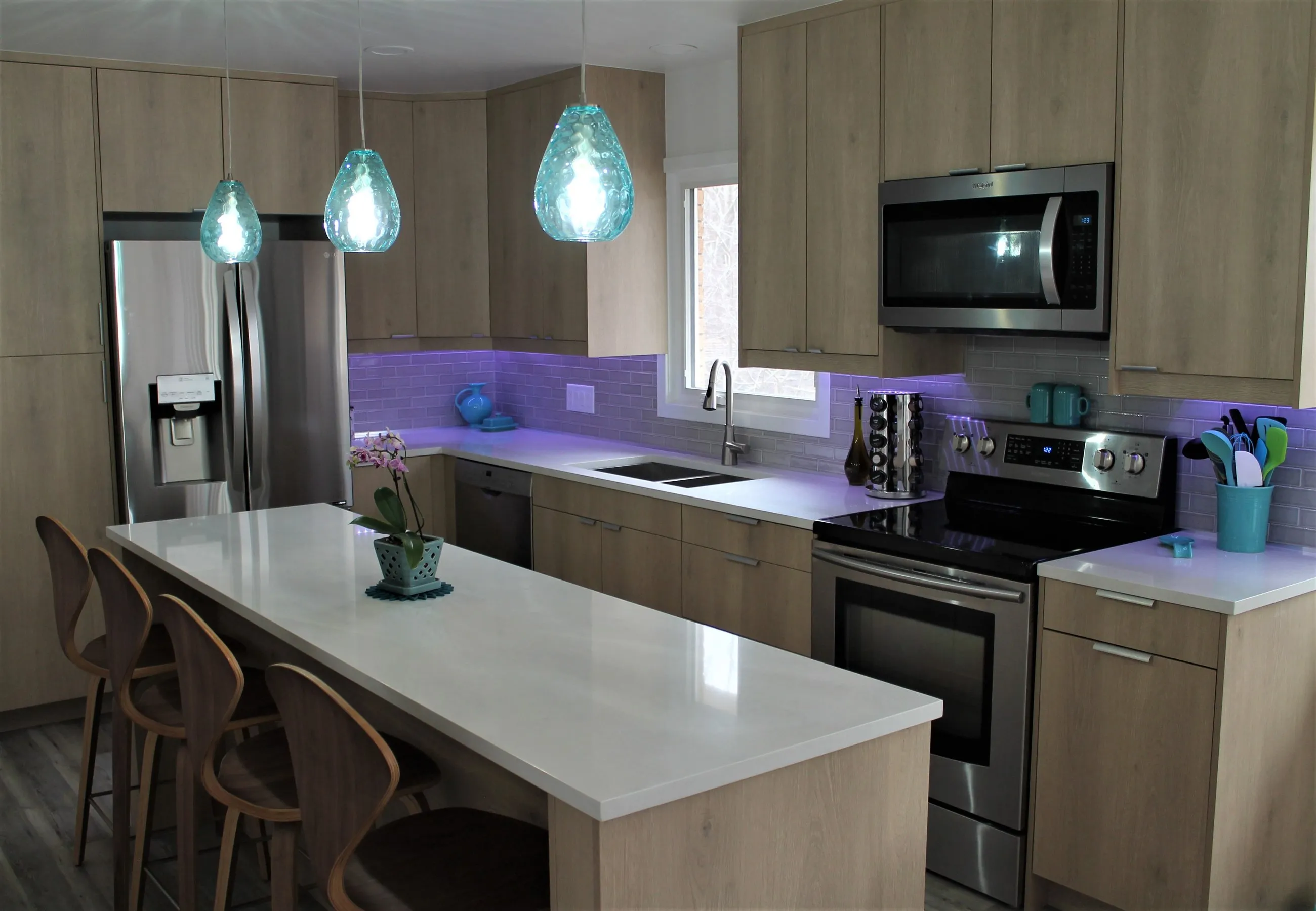 Lit backsplash behind the range in the birch kitchen