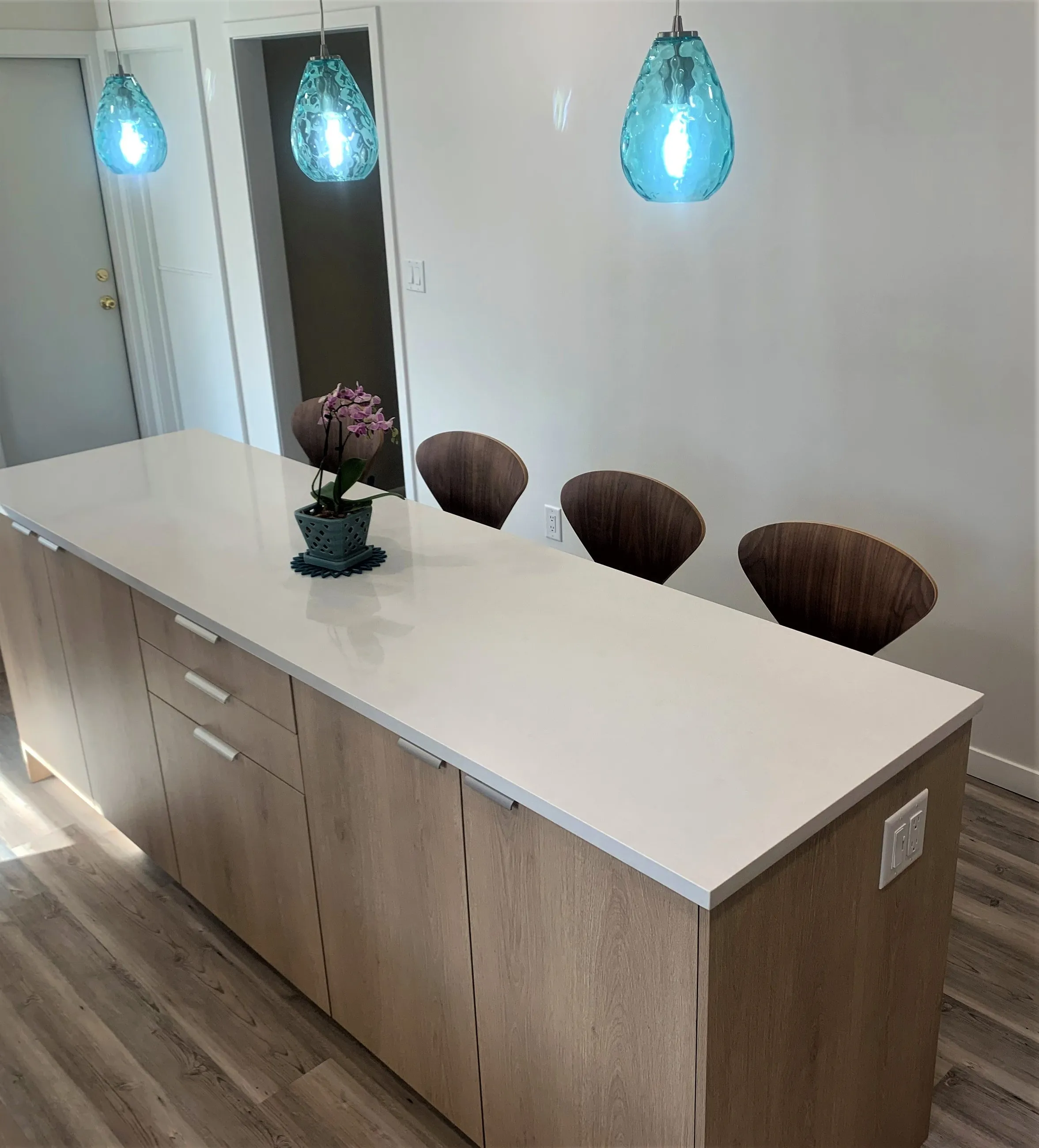 Island end in white quartz and birch cabinetry