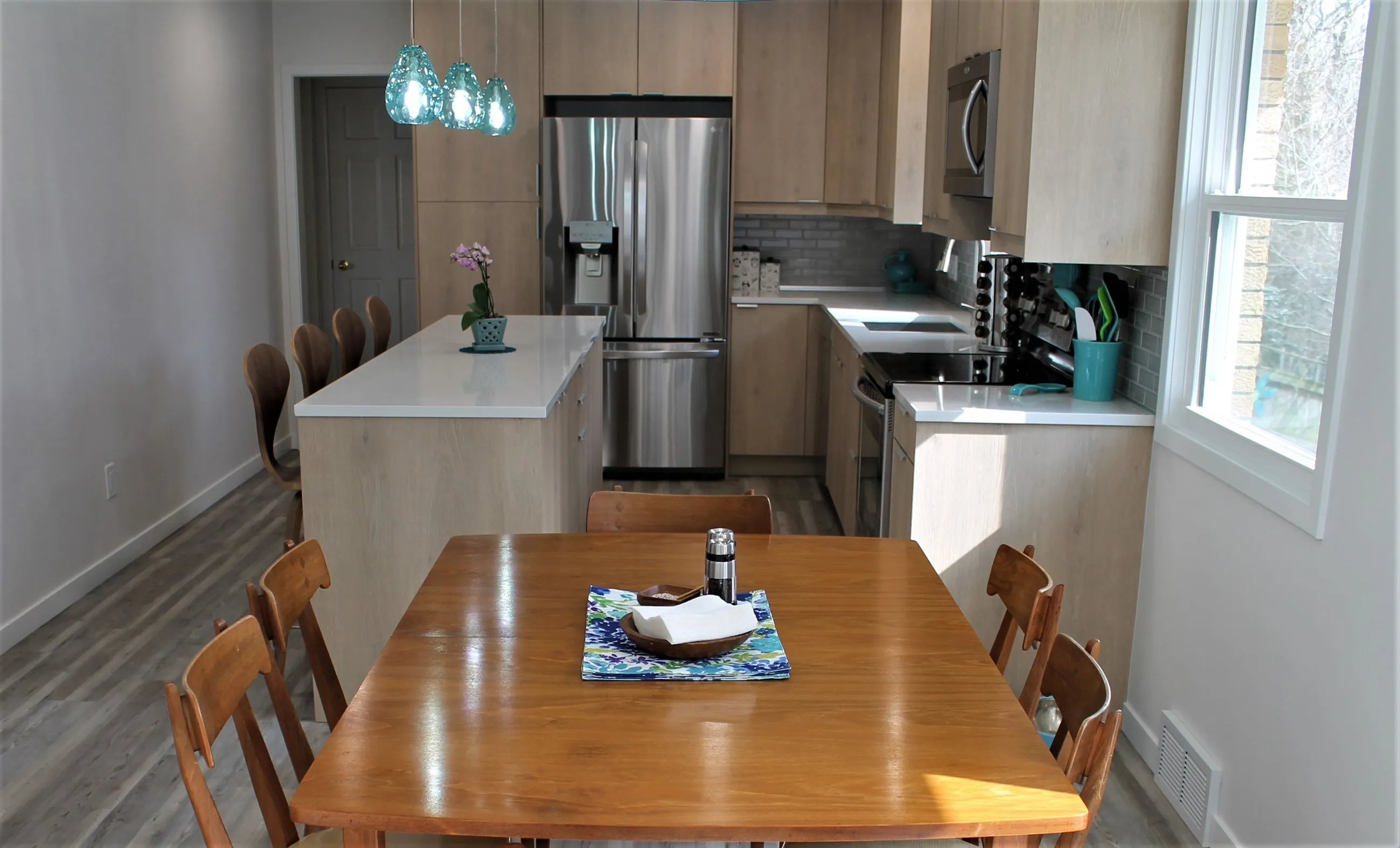 Wood dining table beside the birch kitchen