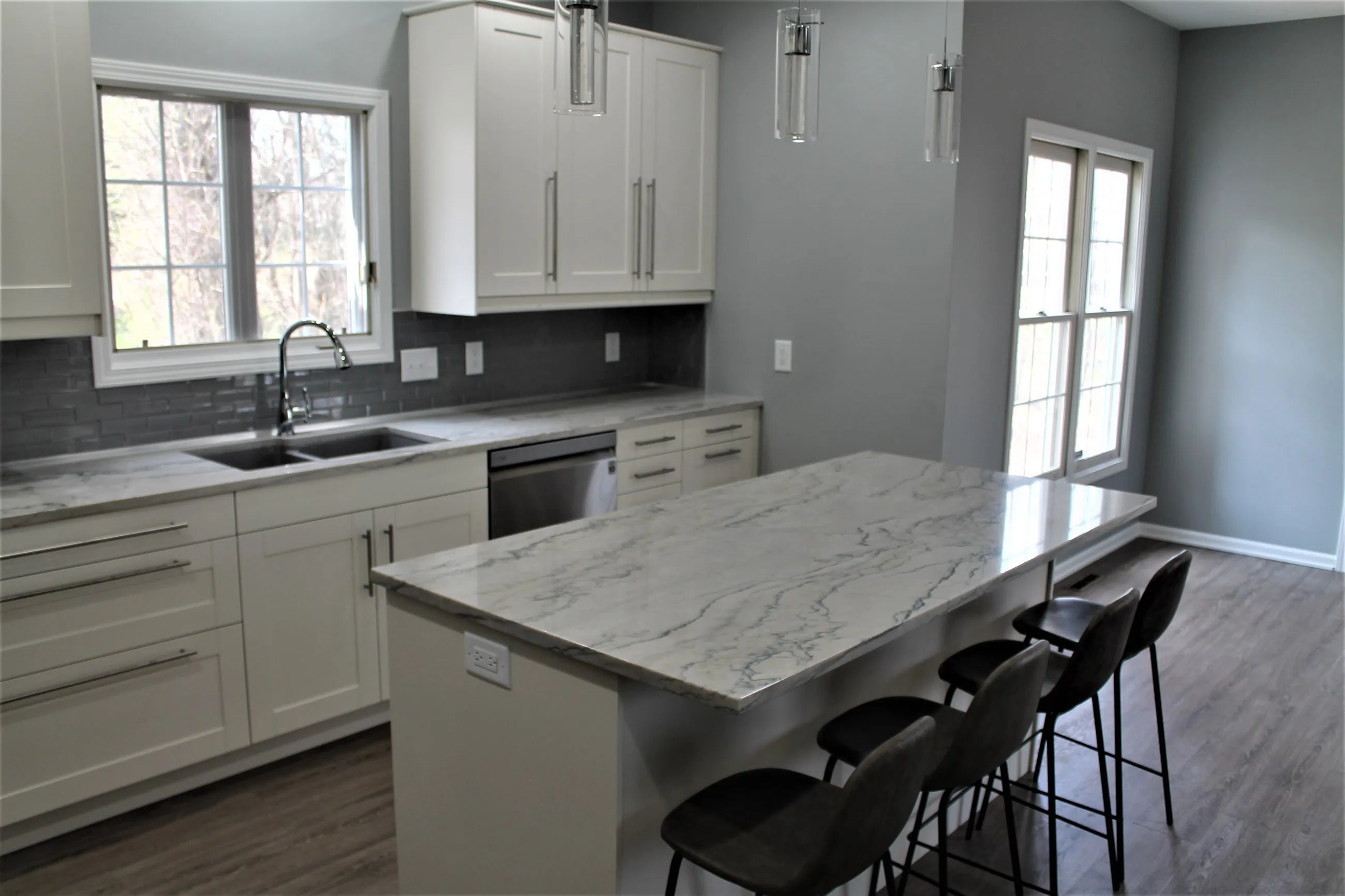 Quartz island with grey stools by the window