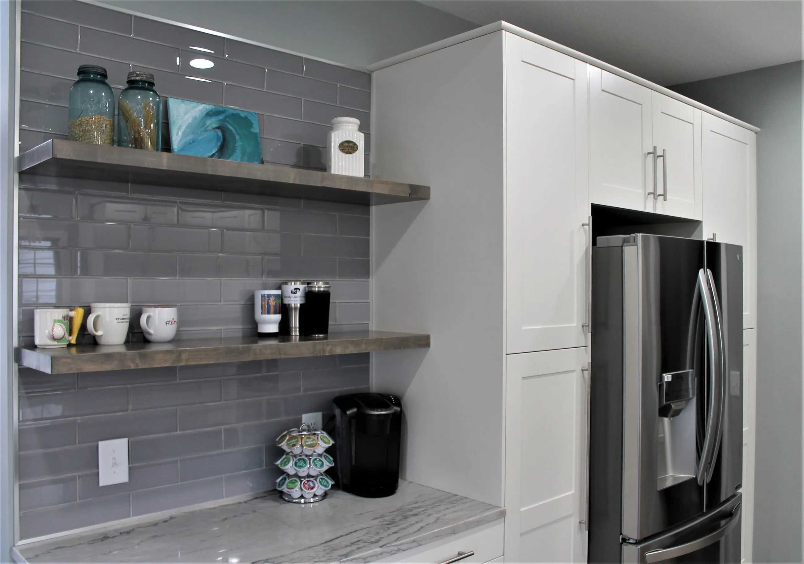 Floating shelves and coffee bar on grey subway tile