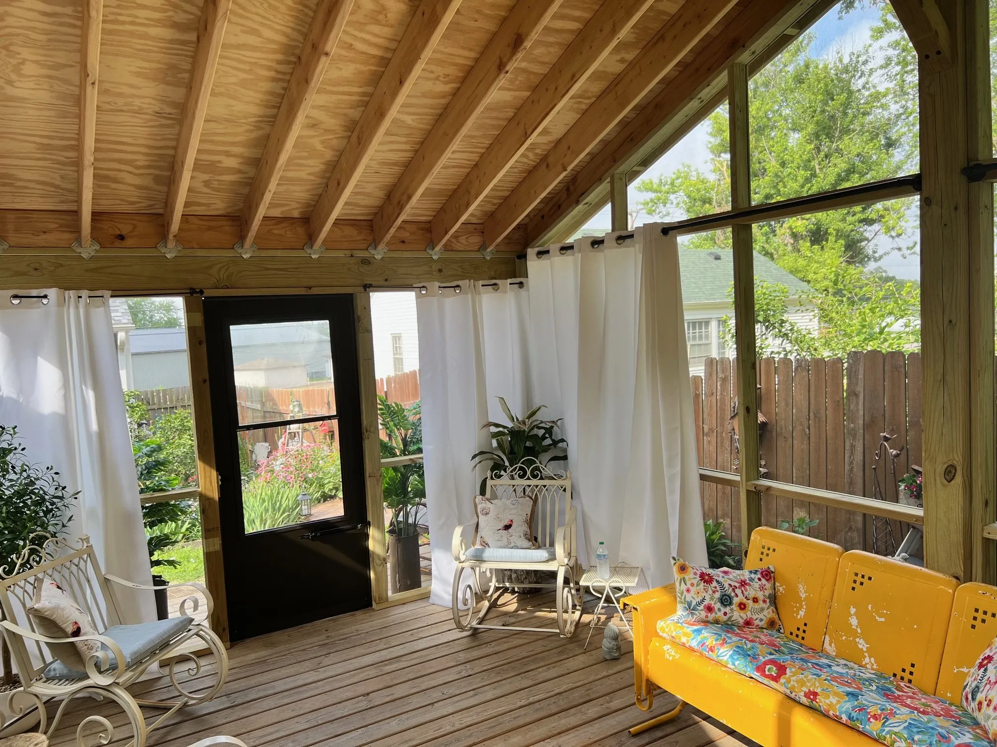Seating corner with white rockers and yellow bench