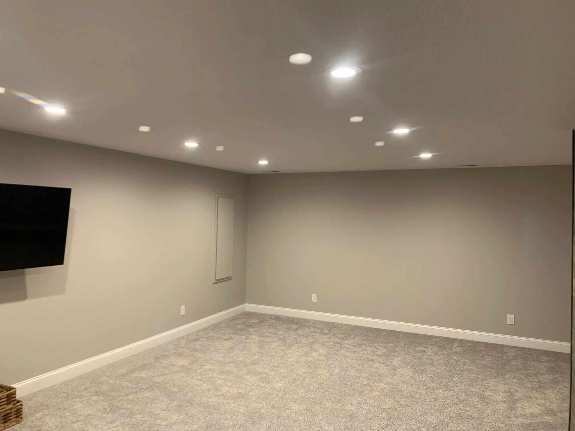 Open carpeted living area with recessed lighting