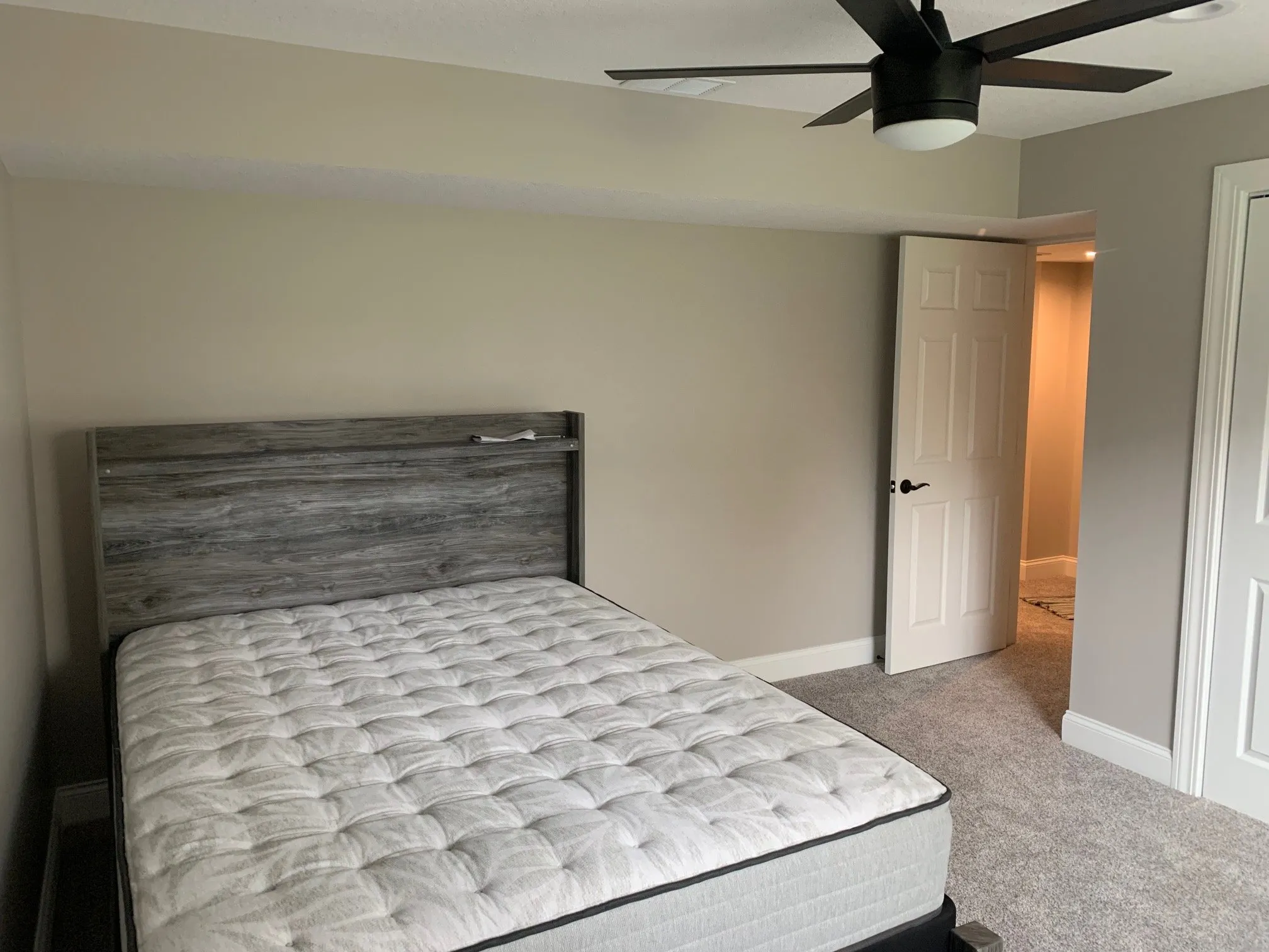 Bedroom with grey plank headboard wall