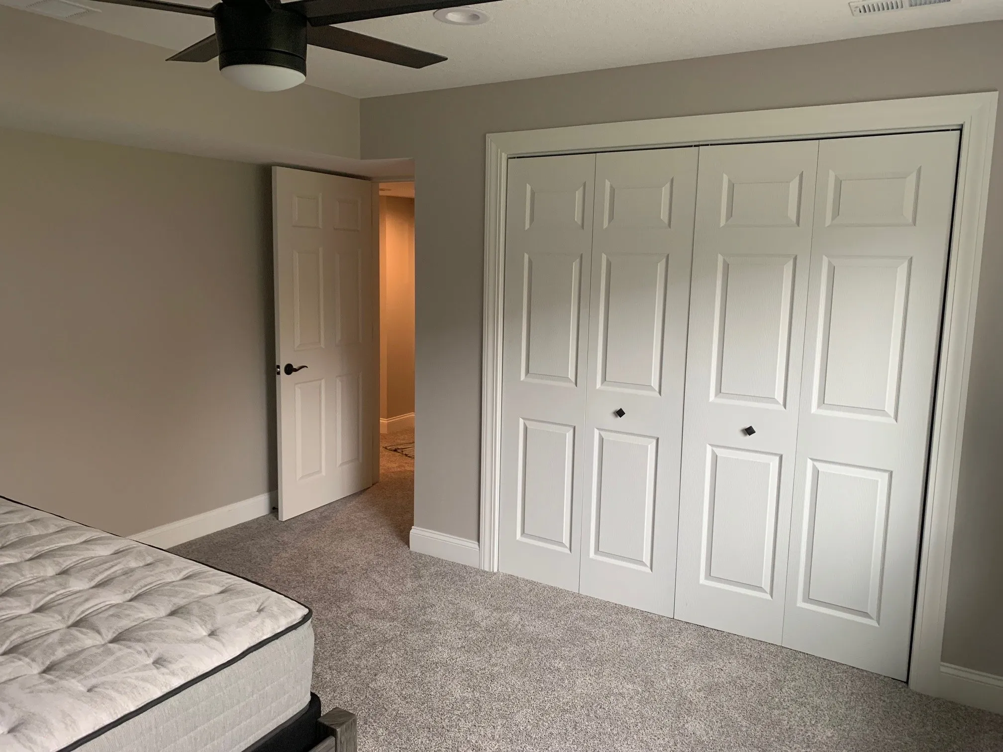 Bedroom closet with white double doors