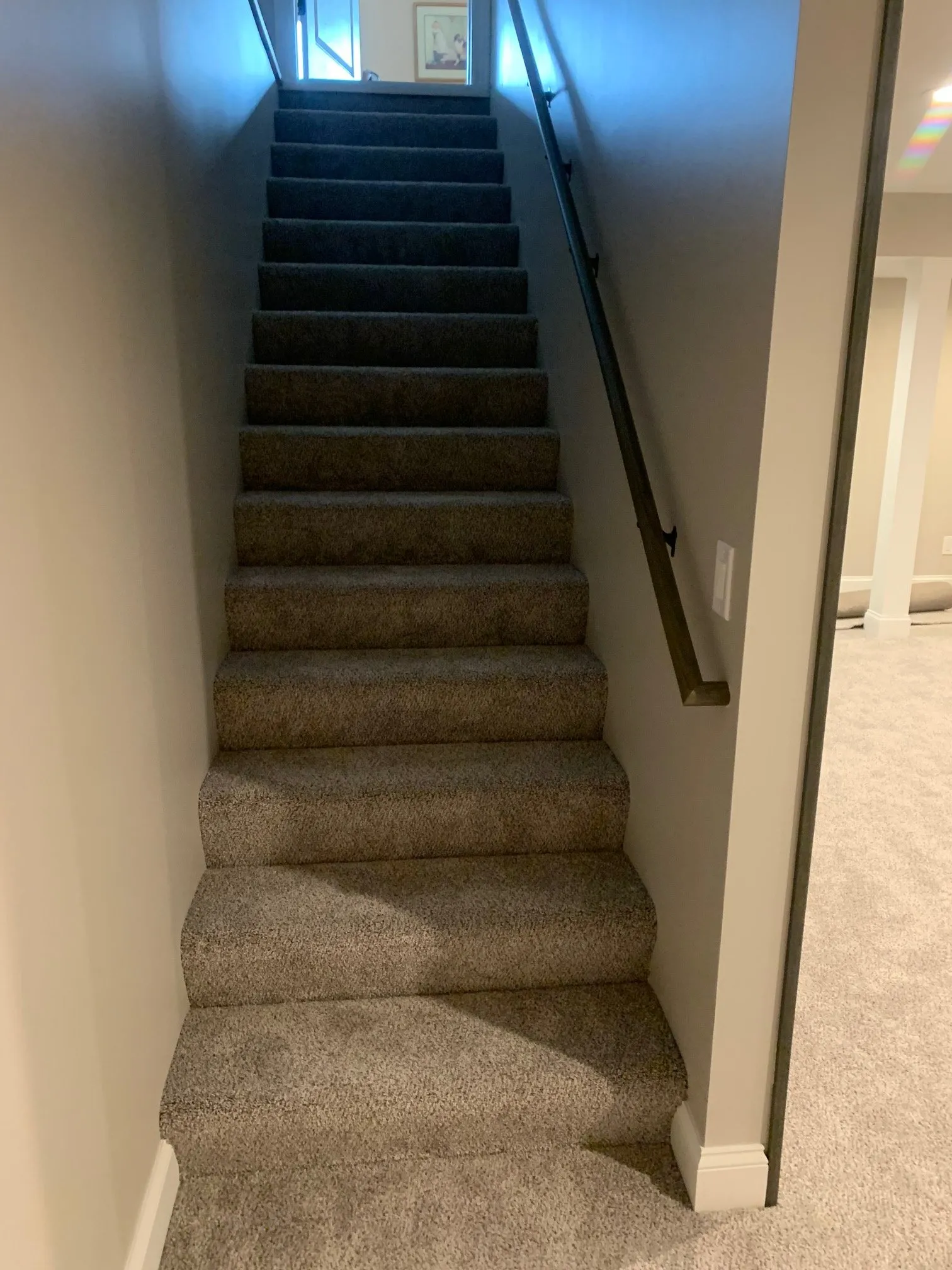Carpeted stair down to the finished basement