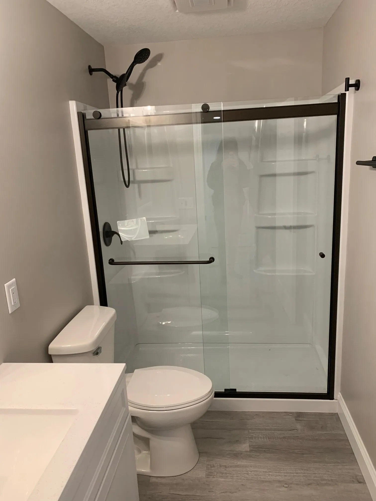 Sliding glass shower door in the basement bath